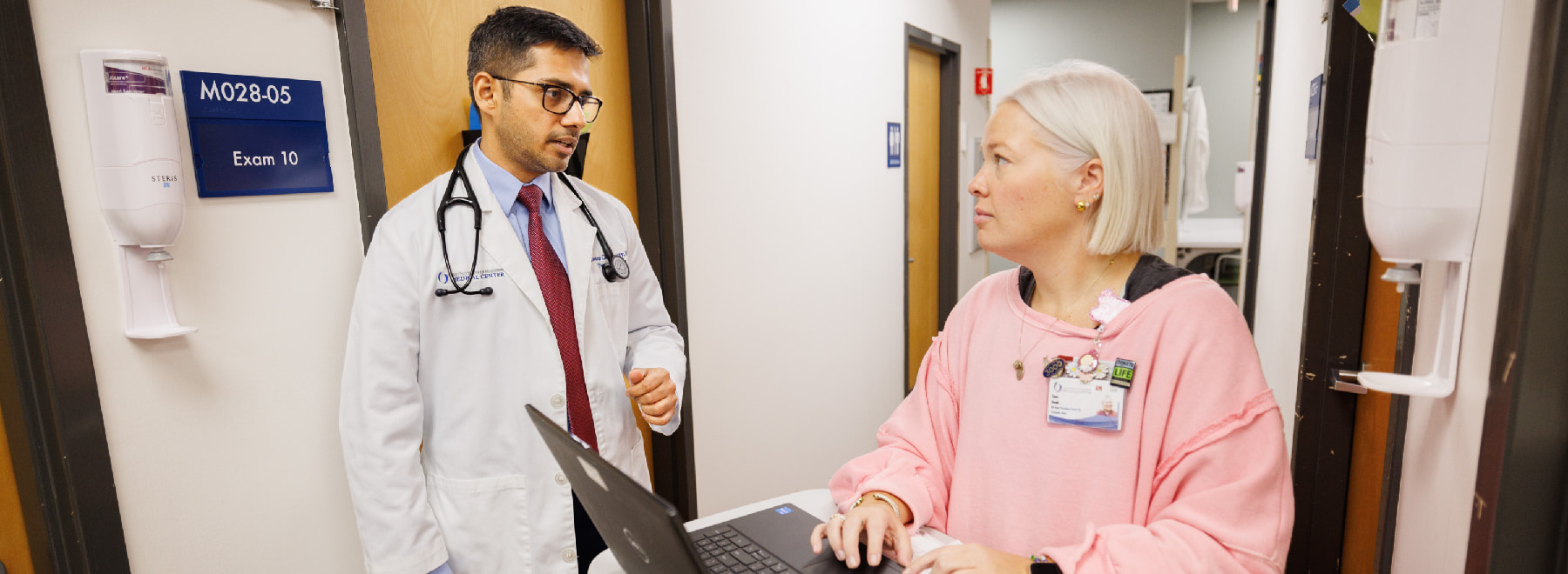 Two health care providers interacting in the Transplant Clinic.